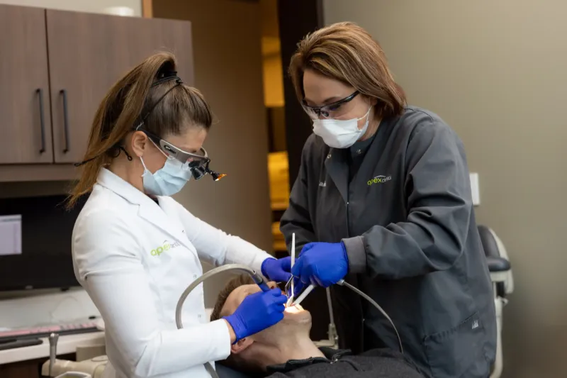 Dentist and assistant treating a patient