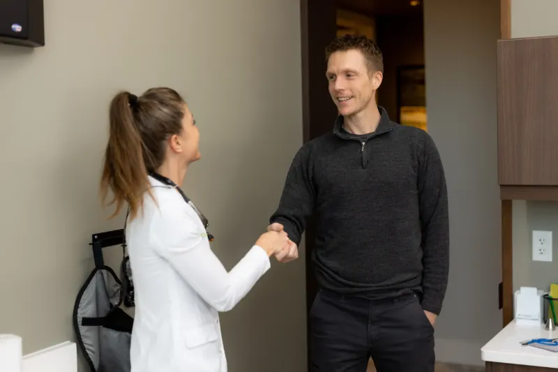 Dentist shaking hands with a patient