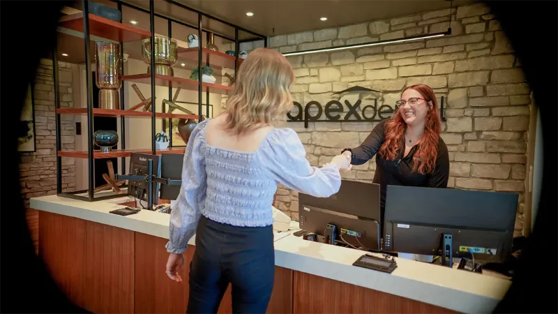 Patient checking in at the Apex Dental front desk
